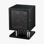 Black watch winder, cubic form with four watches on a white background