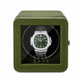Patek Philippe Watch in a green watch winder case on a white background
