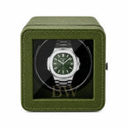 Patek Philippe Watch in a green watch winder case on a white background