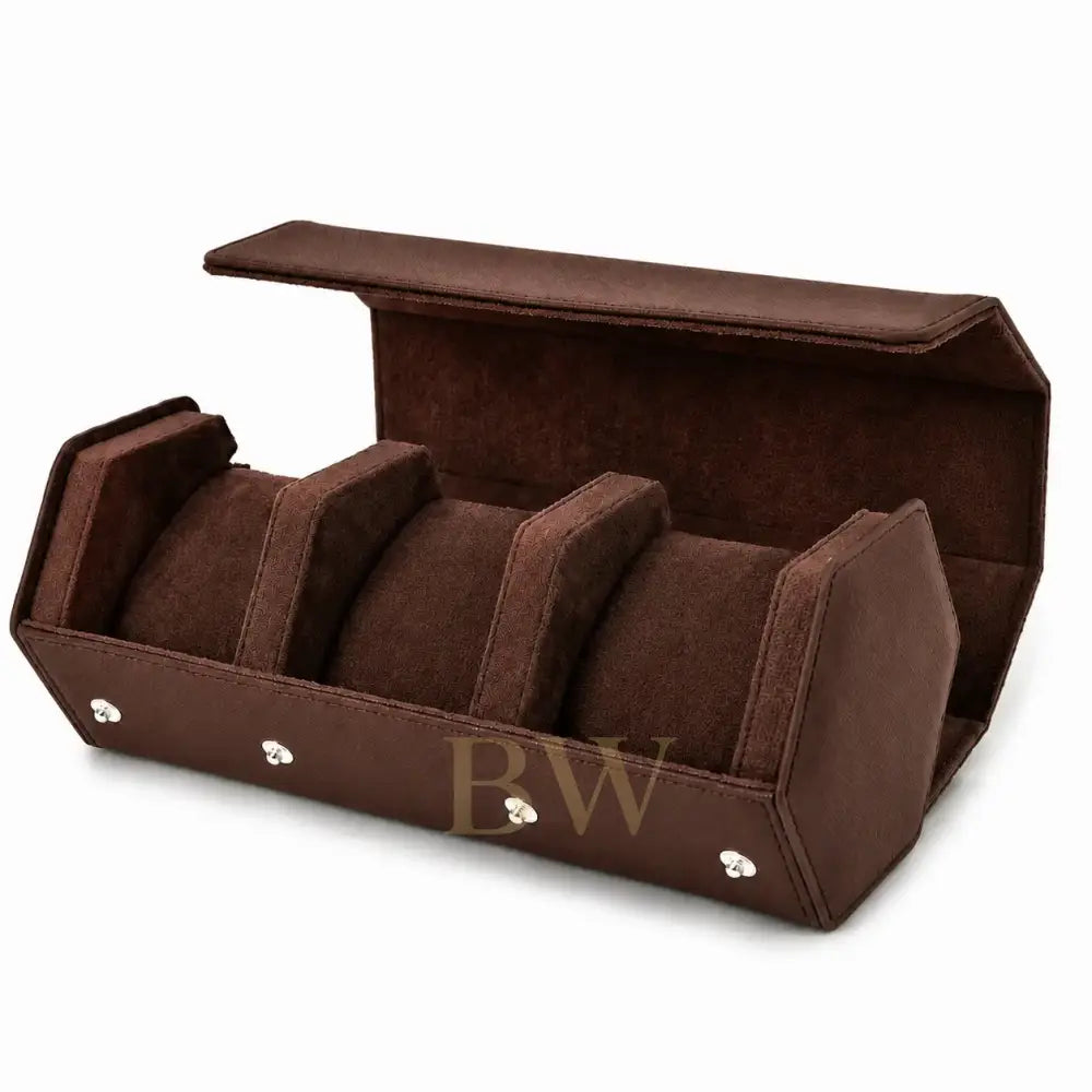 A brown velvet watch travel roll with an open lid, featuring three cylindrical watch roll compartments and silver-tone metal corner accents, shown on a white background.