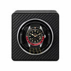 Tudor watch in a black carbon fiber watch winder on a white background