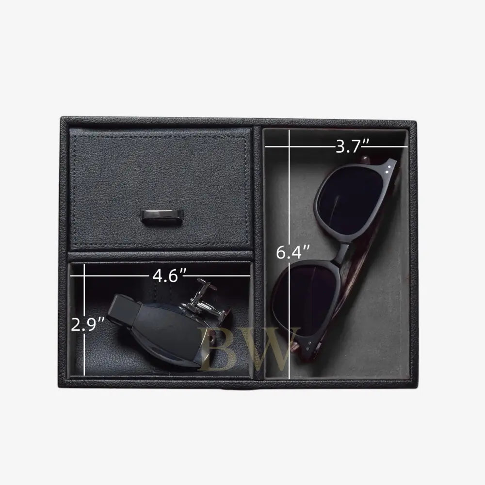 Black leather compartment box with sunglasses and cufflinks, showing dimensions on a white background.