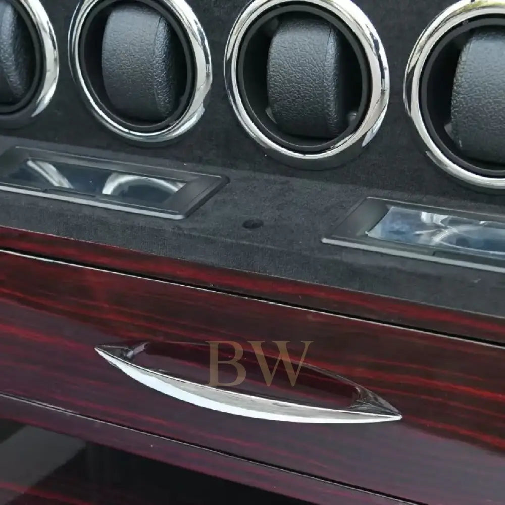 Close-up of a watch winder's interior panel with drawer and rotators.