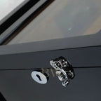 Close-up of a metallic door handle and lock on a watch winder