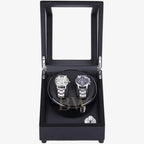 Black watch winder with two watches inside on a white background