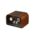 Wooden watch winder with two watches on a white background