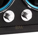 Close-up of two silver knobs of a black watch winder.