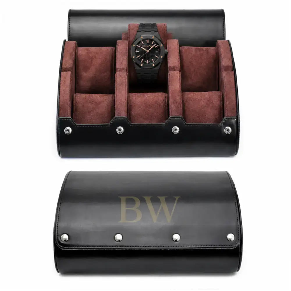A black leather watch storage roll shown open and closed on a white background. The open case reveals brown suede-like interior compartments, and a Audemars Piguet luxury watch inside.