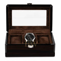 A luxury wooden watch box with a dark wood grain exterior, a clear glass lid, and a brown velvet interior, three watch slots.