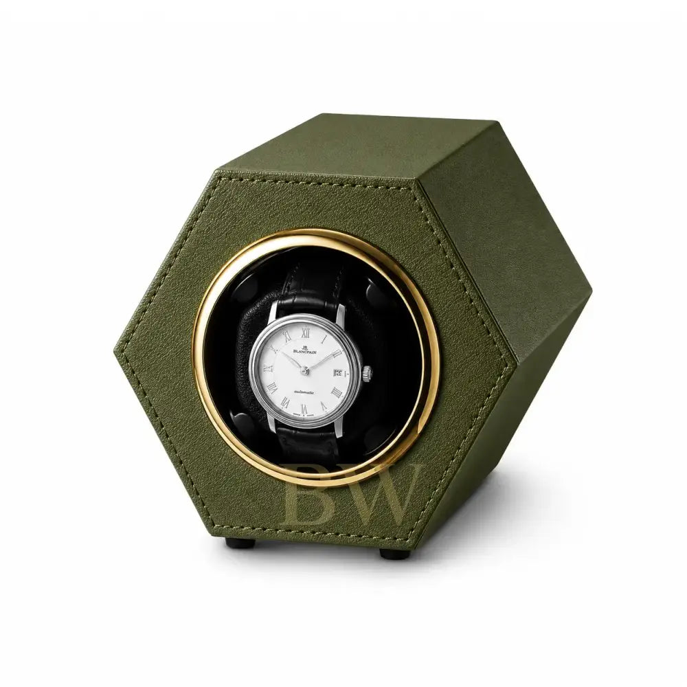 Green hexagonal watch winder with a automatic luxury watch inside on a white background