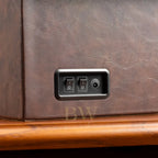 Control panel with switches on a brown leather surface