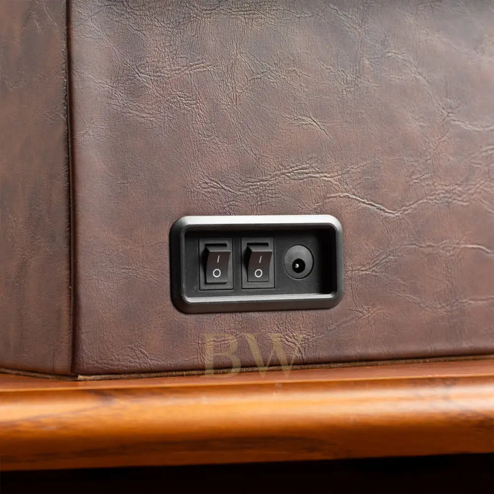 Control panel with switches on a brown leather surface