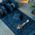 Rolex displayed in a blue watch roll