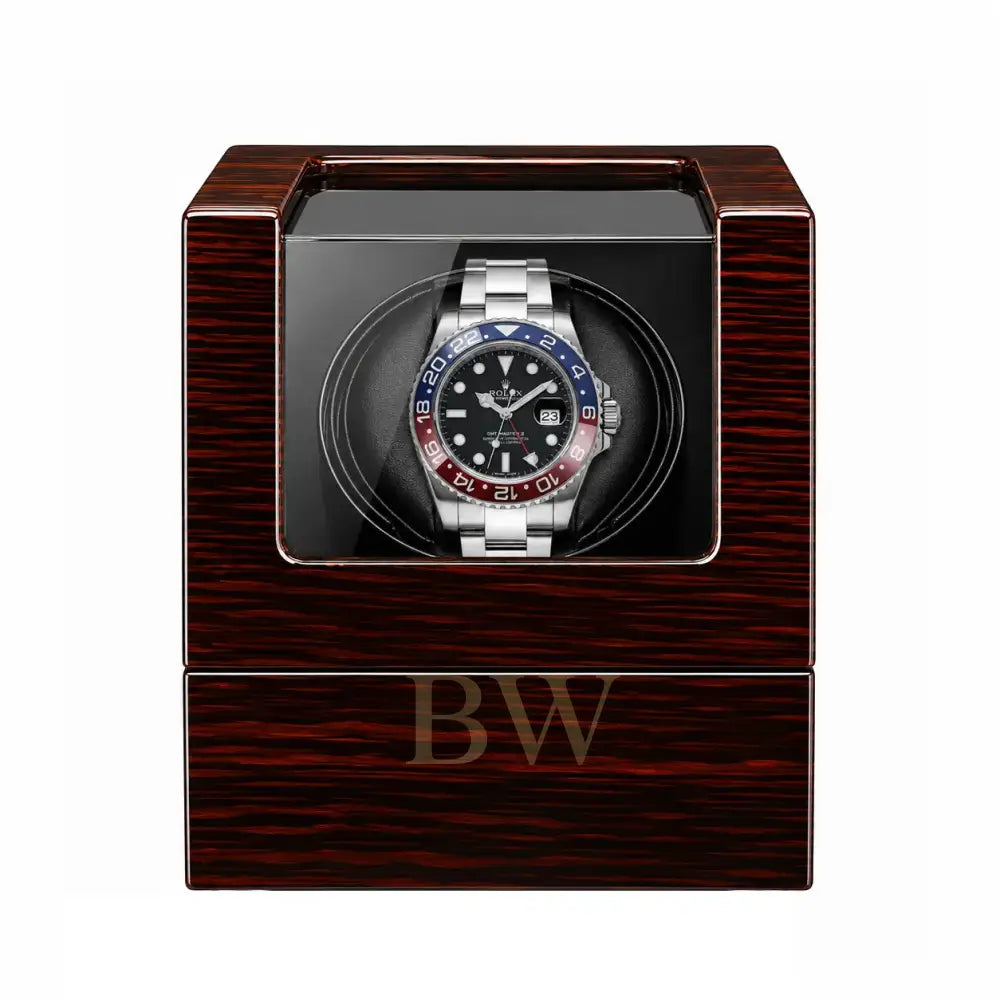 Rolex GMT Master in a wooden vitage watch winder case with a white background