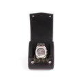 Silver watch in a black leather display case on a white background