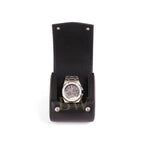 Silver watch in a black leather display case on a white background