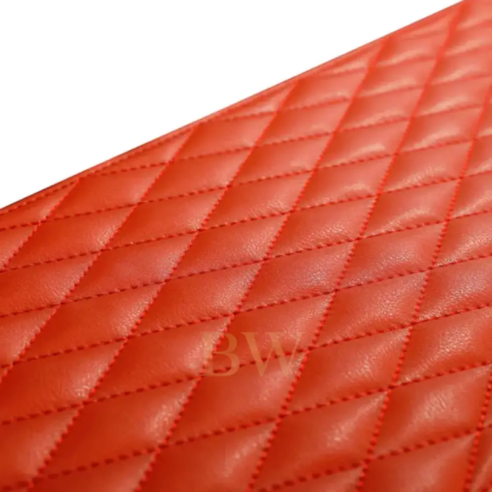 Close-up of a orange quilted leather surface