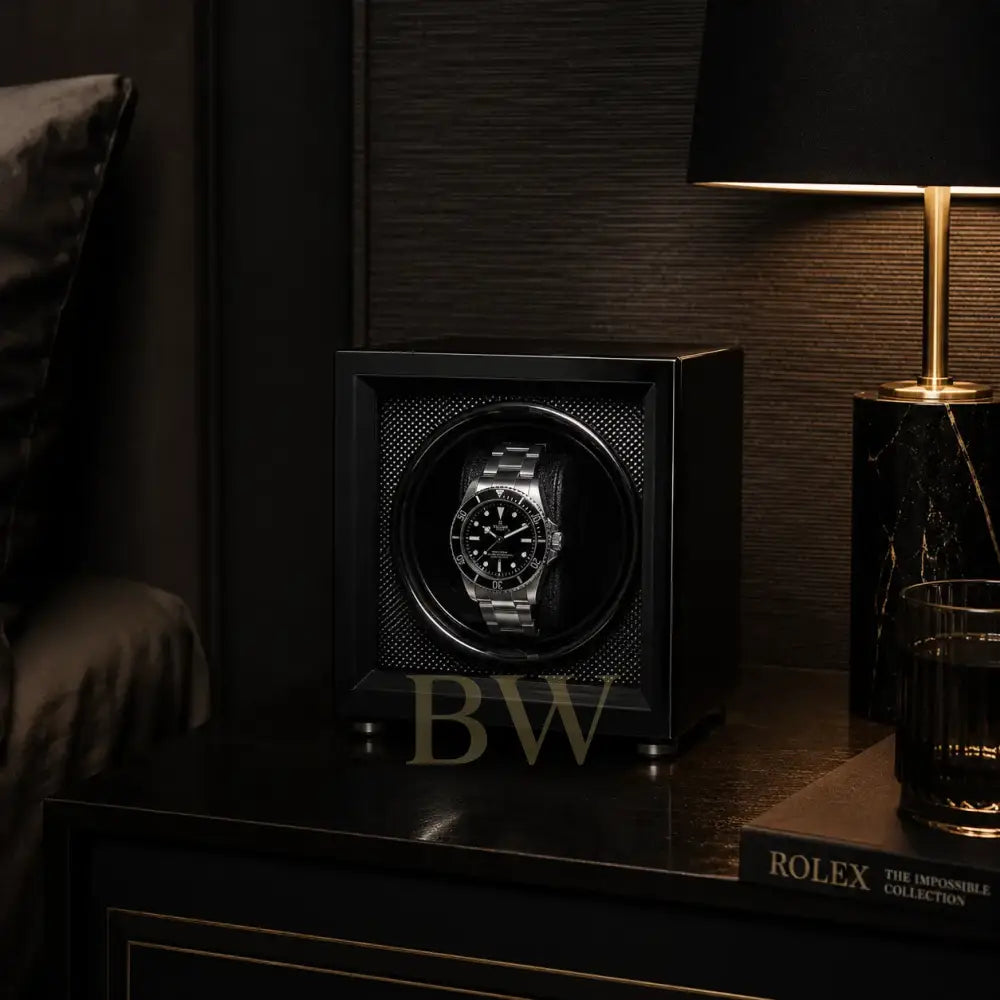 Tudor Black Watch in a watch winder on a night stand