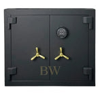 Black safe with gold handles on a white background