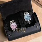 Two watches in a black watch roll 