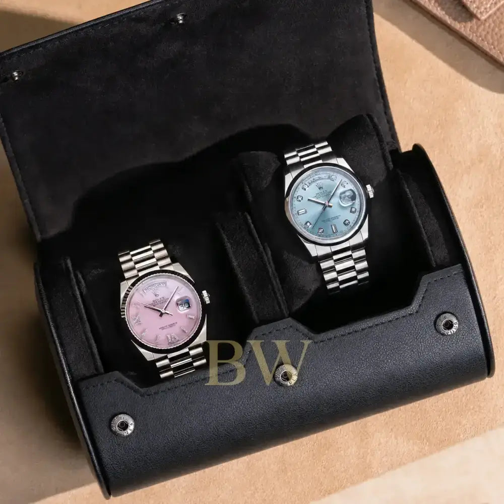 Two watches in a black watch roll 