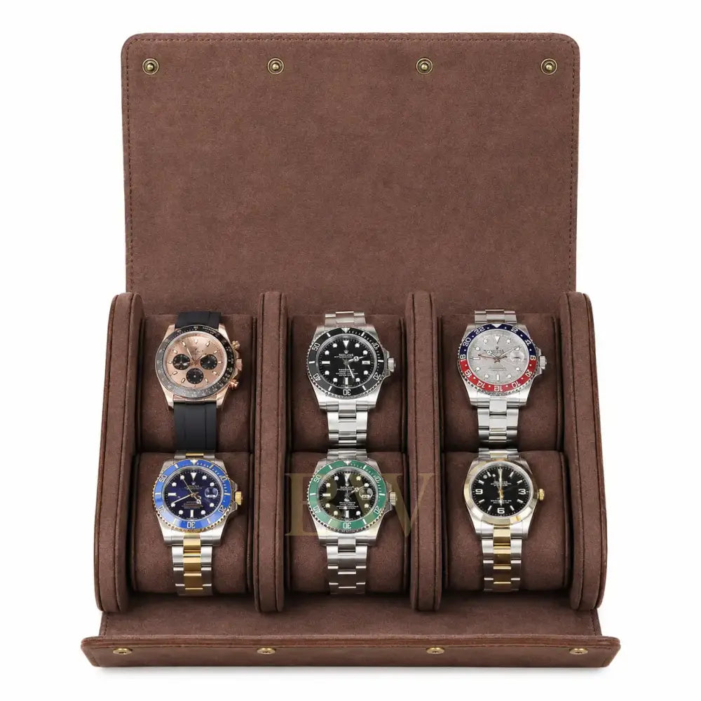 A brown suede watch roll travel storage with six cushioned slots, shown open and filled with six different luxury watches on a white background.