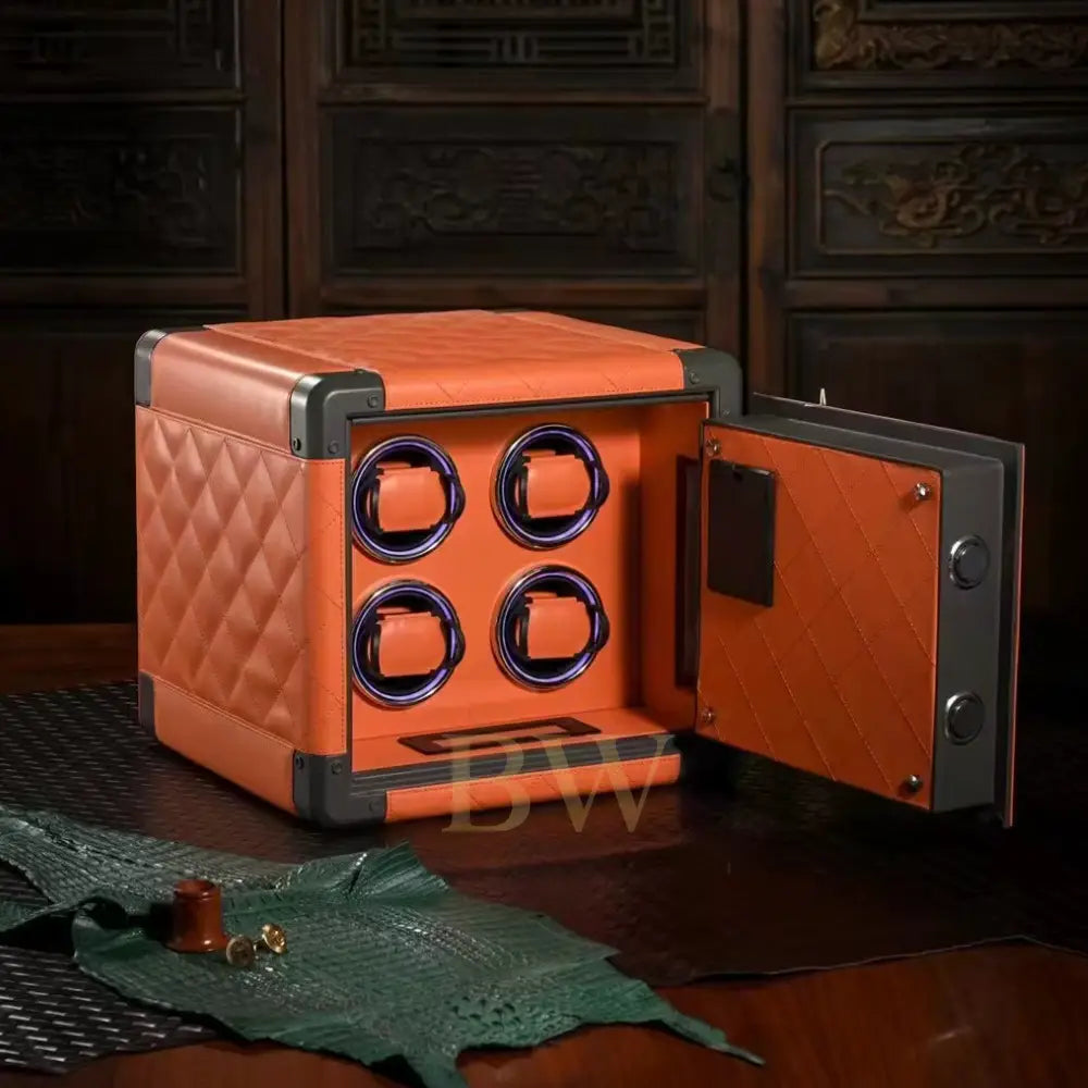 Orange watch winder with open door on a wooden surface