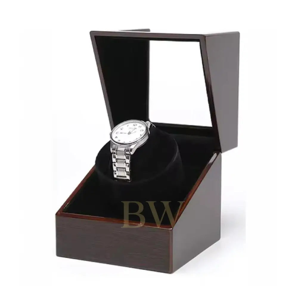 Silver watch in a wooden watch winder box with a white background