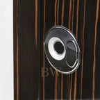 Close-up of a wooden surface with a circular metallic handle.