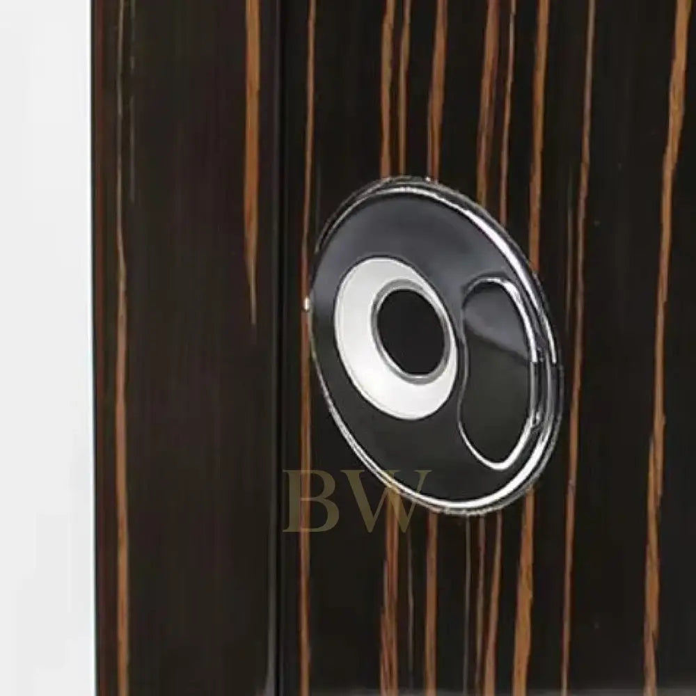 Close-up of a wooden surface with a circular metallic handle.