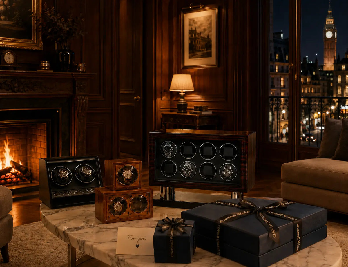 Collection of watch winders for gift on a marble table in a luxurious room with a fireplace and London view.