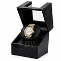 Gold and silver Seiko watch in a black crocodile watch winder patterned box on a white background