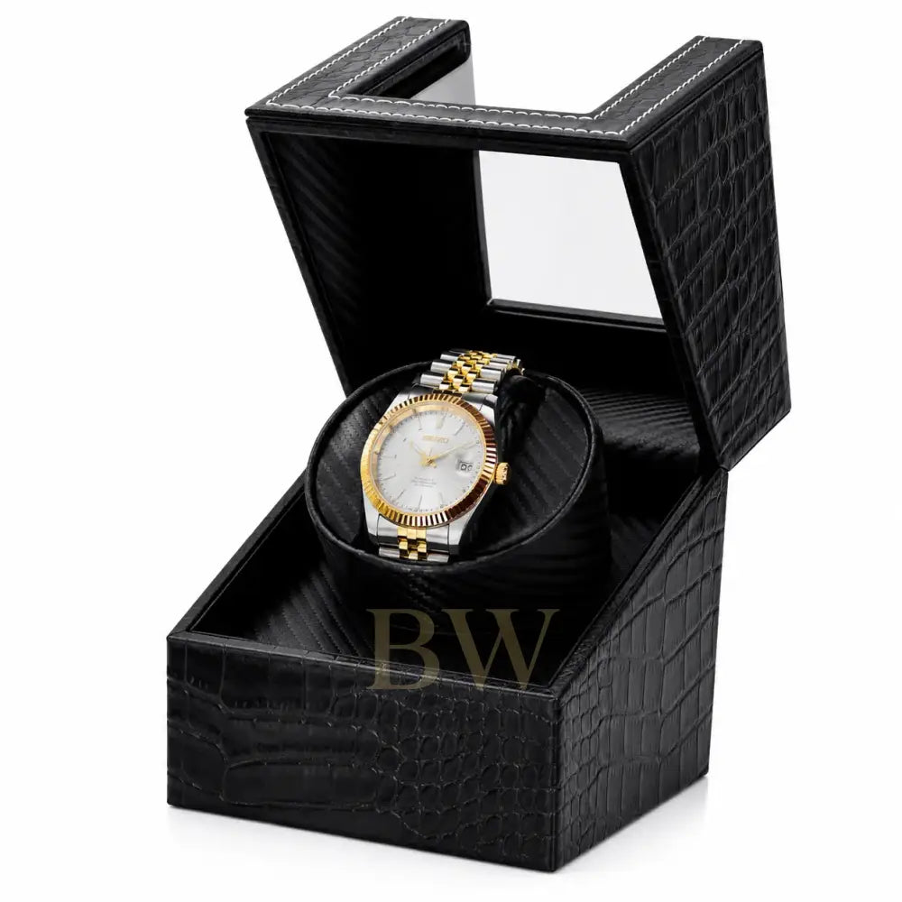 Gold and silver Seiko watch in a black crocodile watch winder patterned box on a white background