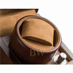 Close-up of a brown leather watch winder in a white background