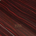 Close-up of a dark red and black ebony wooden surface