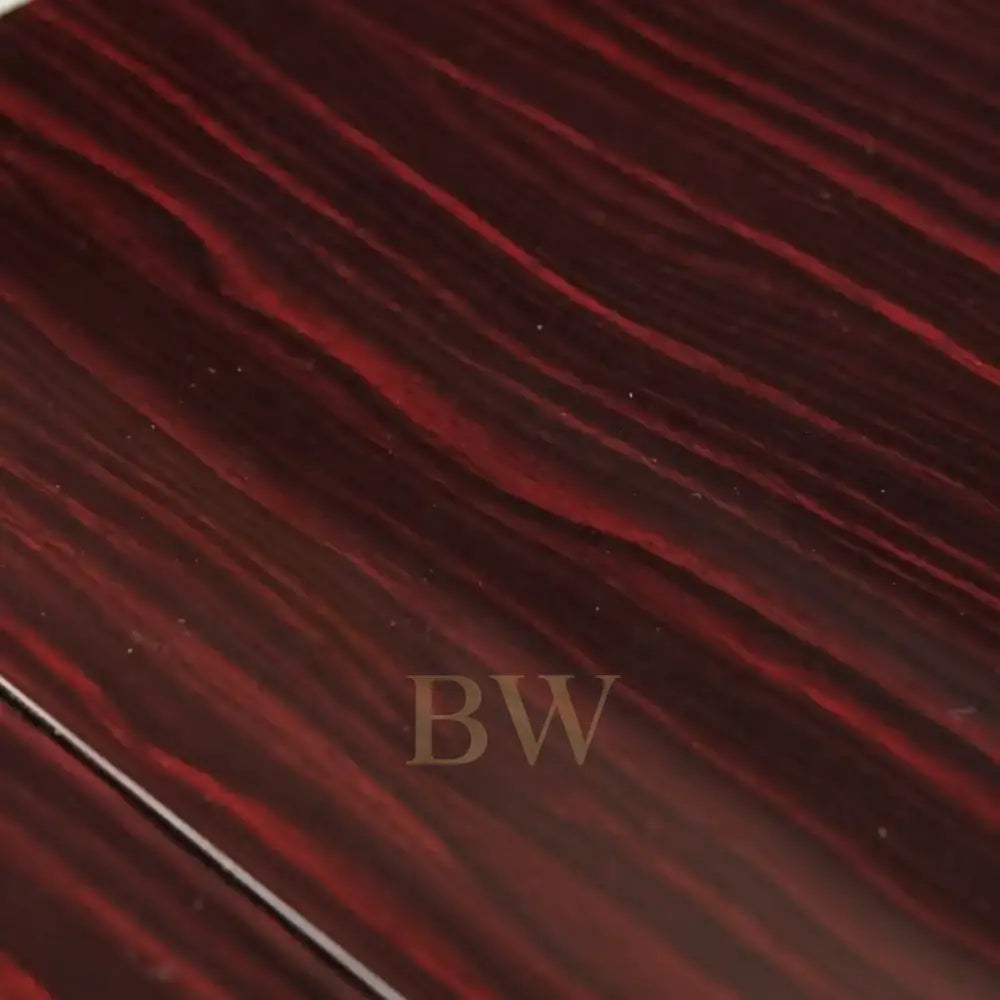 Close-up of a dark red and black ebony wooden surface
