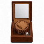 Wooden watch winder box with no watch inside on a white background