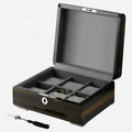 Wooden watch box with compartments and a key on a white background