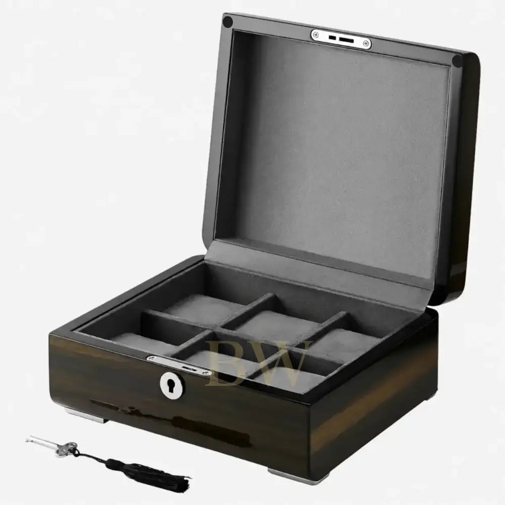 Wooden watch box with compartments and a key on a white background